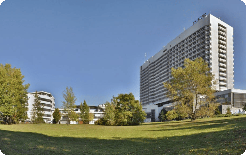 A large building surrounded by trees and grass