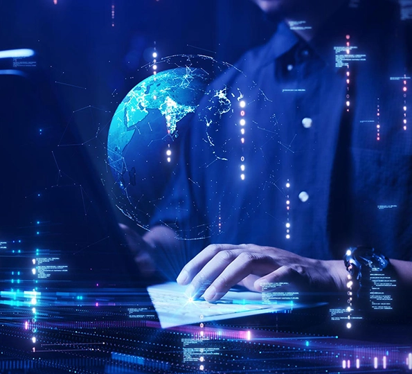 A man on a laptop with an AI artificial globe coming out of the keyboard